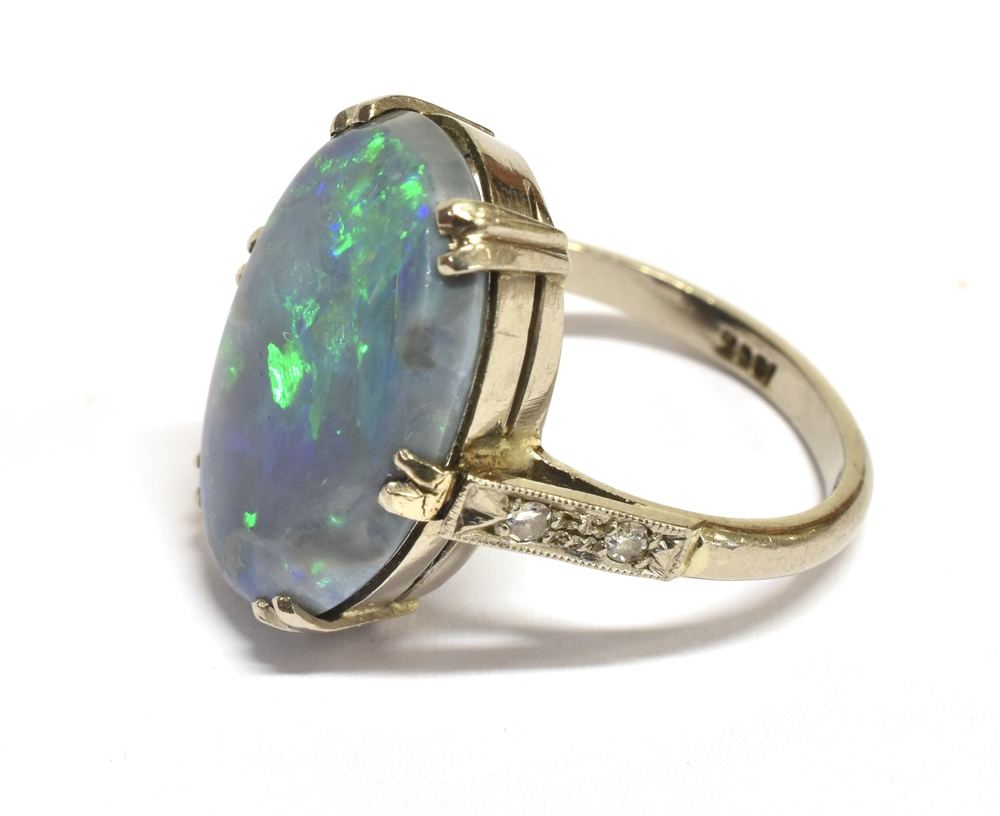 A STAMPED 18CT BLACK OPAL DOUBLET AND DIAMOND RING The large Oval Opal measuring approx. 1.9cm X 1. - Image 3 of 4