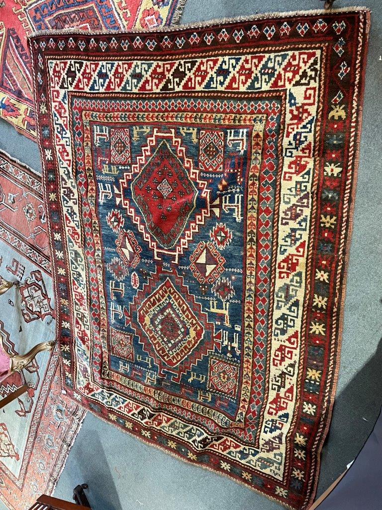 A RED/BLUE GROUND RUG decorated with two medallions and stylised animals, 205cm x 151cm - Image 4 of 7