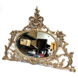A GILT METAL FRAMED MIRROR 104cm wide 78cm high overall, the bevel edged oval mirror 57cm wide