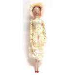 A DUTCH STYLE WOOD PEG DOLL with a lace-effect paper dress, 24.5cm high.