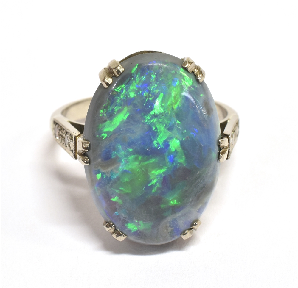 A STAMPED 18CT BLACK OPAL DOUBLET AND DIAMOND RING The large Oval Opal measuring approx. 1.9cm X 1.