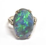 A STAMPED 18CT BLACK OPAL DOUBLET AND DIAMOND RING The large Oval Opal measuring approx. 1.9cm X 1.