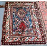 A RED/BLUE GROUND RUG decorated with two medallions and stylised animals, 205cm x 151cm