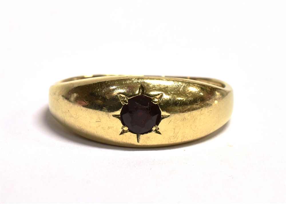 A 9CT GOLD, GARNET GYPSY RING The ring set with a single star set garnet, worn 375 hallmark to the