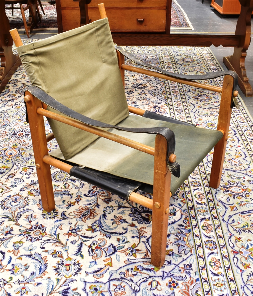 A BEECH FRAMED 'SAFARI' STYLE ARMCHAIR in the manner of Kaare Klint, with canvas slung set and backs