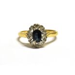 18CT GOLD SAPPHIRE CLUSTER RING The cluster measuring 1.1 x 0.9cm and set with a central oval blue