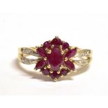 A STAMPED 9K RED STONE FLOWER RING The ring set with a red stone flower measuring 1.1 x 1.1cm in
