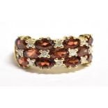 A 9CT GOLD DIAMOND AND SPESSARITE MIXED CUT CLUSTER RING The ring set with a triple band of