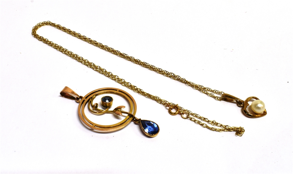 TWO VINTAGE PENDANTS An early 20th century circular open work pendant set with two sapphire paste