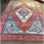 A RED GROUND CARPET with central medallion, 280cm x 395cm