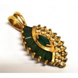 AN EMERALD PENDANT PIECE The navette shaped pendant set with eight baguette cut emeralds, one