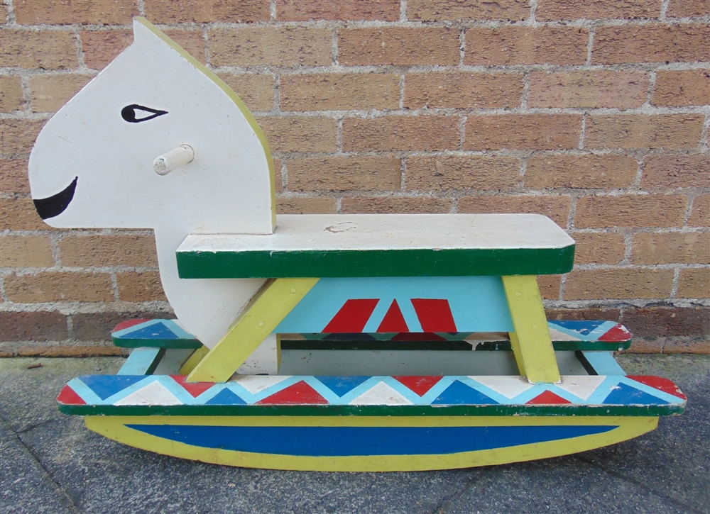 A PAINTED WOOD ROCKING HORSE on shallow bow rockers, overall 91cm long.