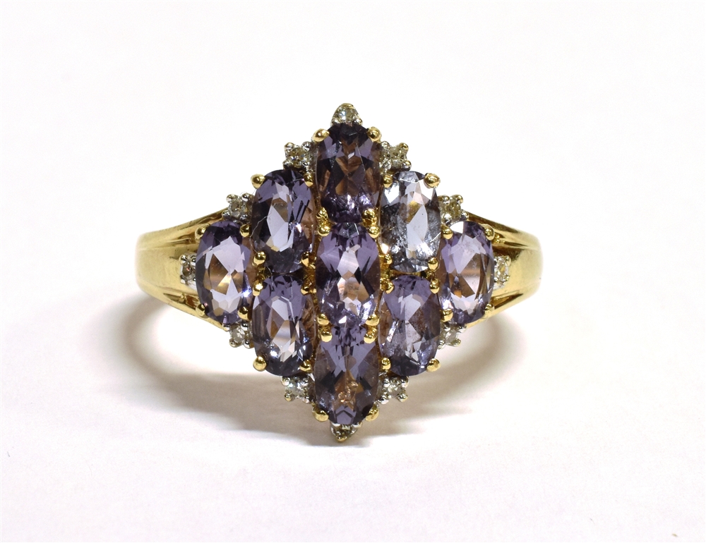 A 9CT GOLD AMETHYST CLUSTER RING The lozenge shaped cluster set with nine round cut light