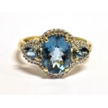 QVC 9CT GOLD SAPPHIRE CLUSTER RING The ring set with a faceted oval sky blue sapphire measuring 9