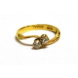 AN 18CT GOLD, DIAMOND TWO STONE CROSSOVER RING The two diamonds each measuring approx 2mm in