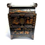 A JAPANESE LAQUERED TABLE TOP CABINET fitted with drawer above pair of doors opening to six drawers,