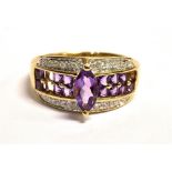 QVC 9CT GOLD GEMSET CLUSTER RING The cluster comprising of a central band of small round cut
