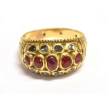 A RUBY AND SAPPHIRE CLUSTER RING The horizontal dome cluster set with five graduated oval rubies and