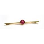 A MARKED 15CT PINK SPINEL BAR BROOCH Length 5.6cm, round cut spinel diameter 8mm, weight 3.5g