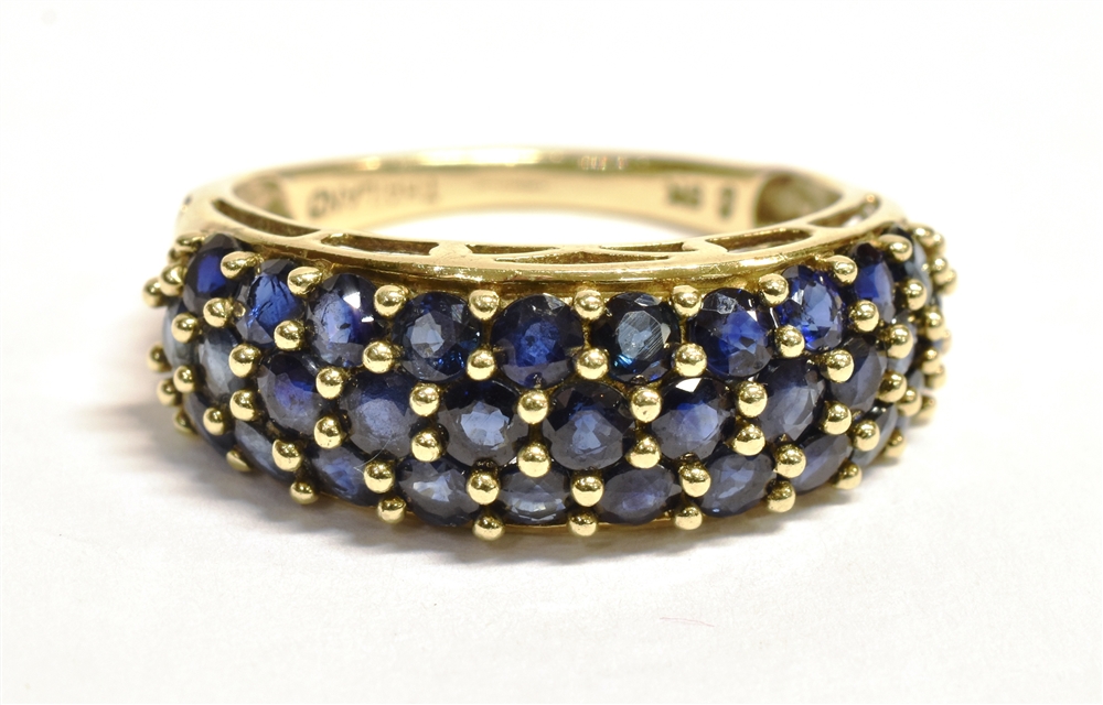 A 9CT GOLD SAPPHIRE CLUSTER RING The cluster made up of a triple row of small near black