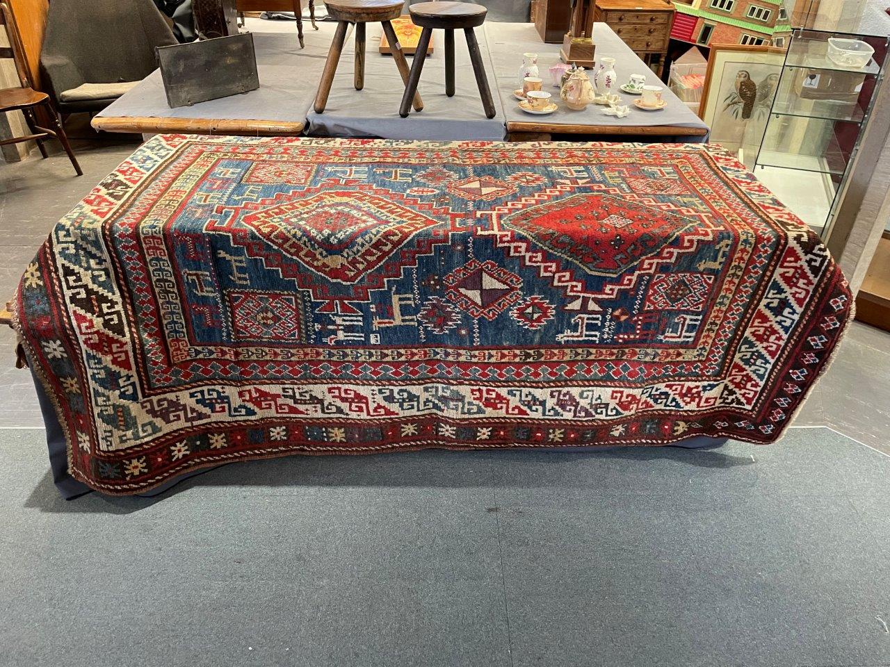 A RED/BLUE GROUND RUG decorated with two medallions and stylised animals, 205cm x 151cm - Image 5 of 7