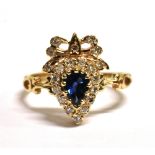9CT GOLD, SAPPHIRE AND DIAMOND CLUSTER RING The dark blue pear cut sapphire mounted with diamonds