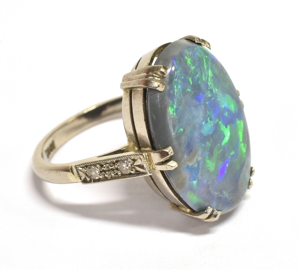 A STAMPED 18CT BLACK OPAL DOUBLET AND DIAMOND RING The large Oval Opal measuring approx. 1.9cm X 1. - Image 2 of 4