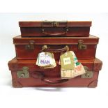 THREE BROWN LEATHER SUITCASES one with attached flight labels, the largest 18cm high, 56cm wide,