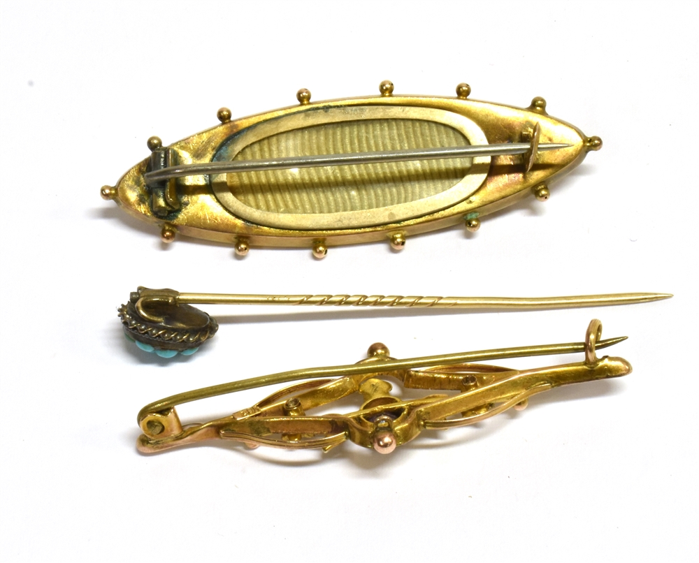 THREE ITEMS OF LATE 19TH/EARLY 20TH CENTURY JEWELLERY A navette shaped Etruscan style brooch, set