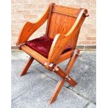 A PITCH PINE GLASTONBURY ARMCHAIR with loose squab cushion, 71cm wide 88cm high Condition Report :