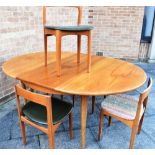 A G-PLAN STYLE TEAK EXTENDING CIRCULAR DINING TABLE and five chairs, the table 122cm diameter, 166cm