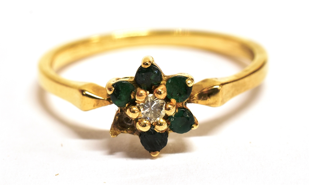 A DIAMOND AND GREEN STONE FLOWER HEAD RING The ring set with a small central diamond with green