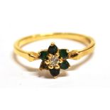 A DIAMOND AND GREEN STONE FLOWER HEAD RING The ring set with a small central diamond with green