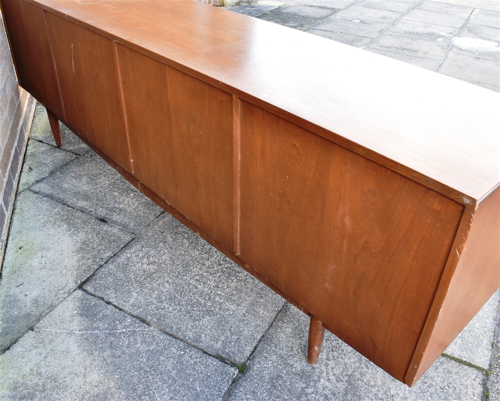 A 1960S TEAK SIDEBOARD fitted with four drawers flanked to one side with drop-down cupboard - Image 3 of 3