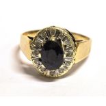 A SAPPHIRE AND DIAMOND CLUSTER RING The near black sapphire mounted with diamonds on an unmarked