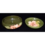 TWO MOORCROFT POTTERY ITEMS DECORATED IN THE 'HIBISCUS' PATTERN on a green ground: a dish 14cm