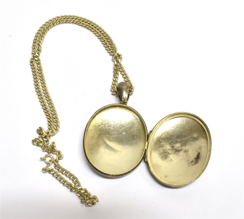 A LATE VICTORIAN SILVER LOCKET WITH CHAIN The large oval locket with chased floral design - Image 2 of 3