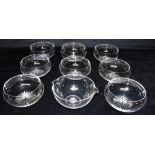 EIGHT MATCHING VICTORIAN GLASS FINGER BOWLS with star cut bases, 12cm diameter; together with a