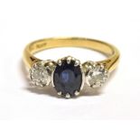 A DIAMOND AND SAPPHIRE THREE STONE RING The ring set with a faceted oval blue sapphire measuring 6mm