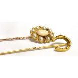 TWO STICK PINS A stamped 18 yellow metal horse shoe stick pin length 5.5cm, a seed pearl and Opalite