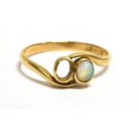 MARKED 18CT OPAL WRAP OVER RING The ring set with a small precious Opal (one Opal missing) 5mm x