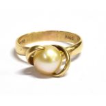 A 9CT GOLD CULTURED PEARL RING The pearl in tension set wrap over mount, measuring 7mm in