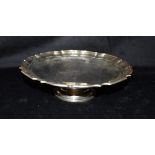 A SILVER PEDESTAL TRAY the circular tray with pie crust border measuring 26.5cm in diameter,
