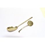 TWO SILVER SPOONS A silver serving spoon, length 24cm, a silver straining spoon with berry patterned