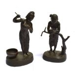 A PAIR OF SOUTH EAST ASIAN BRONZE FIGURES modelled as peasants, standing on raised oval bases,