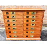 SHOPFITTING/HABERDASHERY INTEREST: a late Victorian mahogany bank of fourteen drawers, each