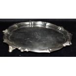 AN EDWARDIAN FOOTED SILVER SALVER The salver with fancy raised border on three feet with a central