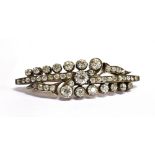 ANTIQUE DIAMOND BROOCH The curved brooch set with approximately 40 graduated old cut diamonds,