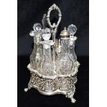 A VICTORIAN SILVER CONDIMENT STAND The stand fitted with six cut glass bottles, four with glass