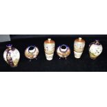 THREE PAIRS OF JAPANESE SATSUMA VASES: a pair of baluster shaped vases decorated with seated geisha,